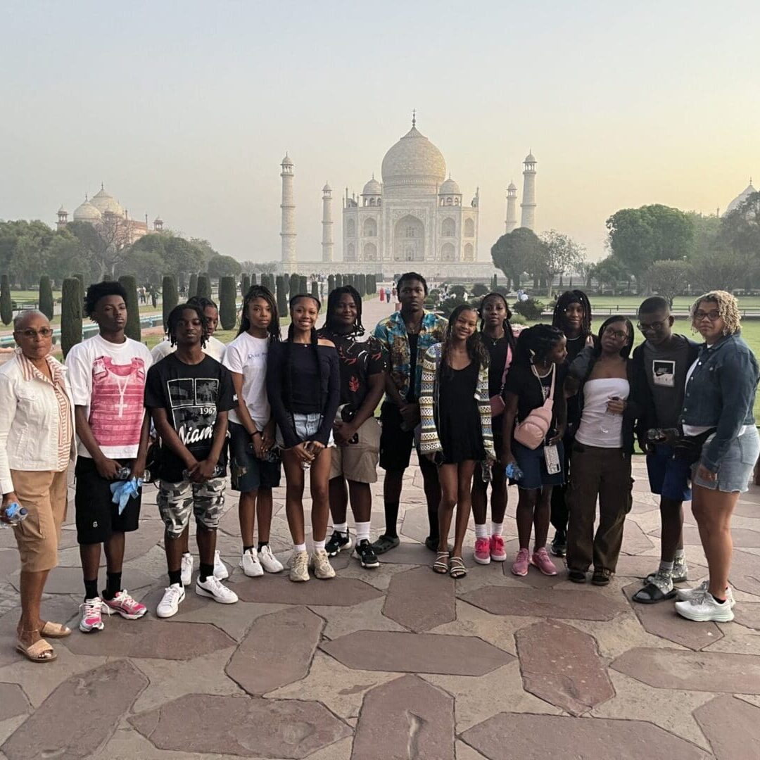 IMG_6995 A group of people standing in front of the taj mahal.